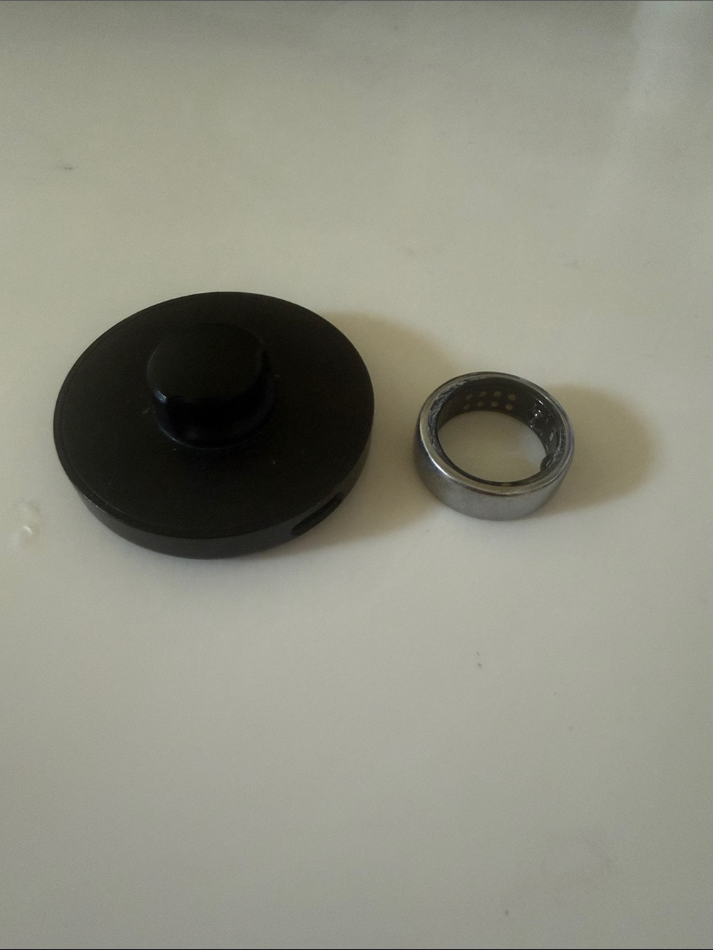 Oura Black and Silver Smart Ring Charging Dock and Ring